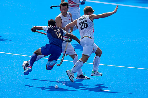 India's Lalit Kumar Upadhyay, left, fights for the ball with Belgium players